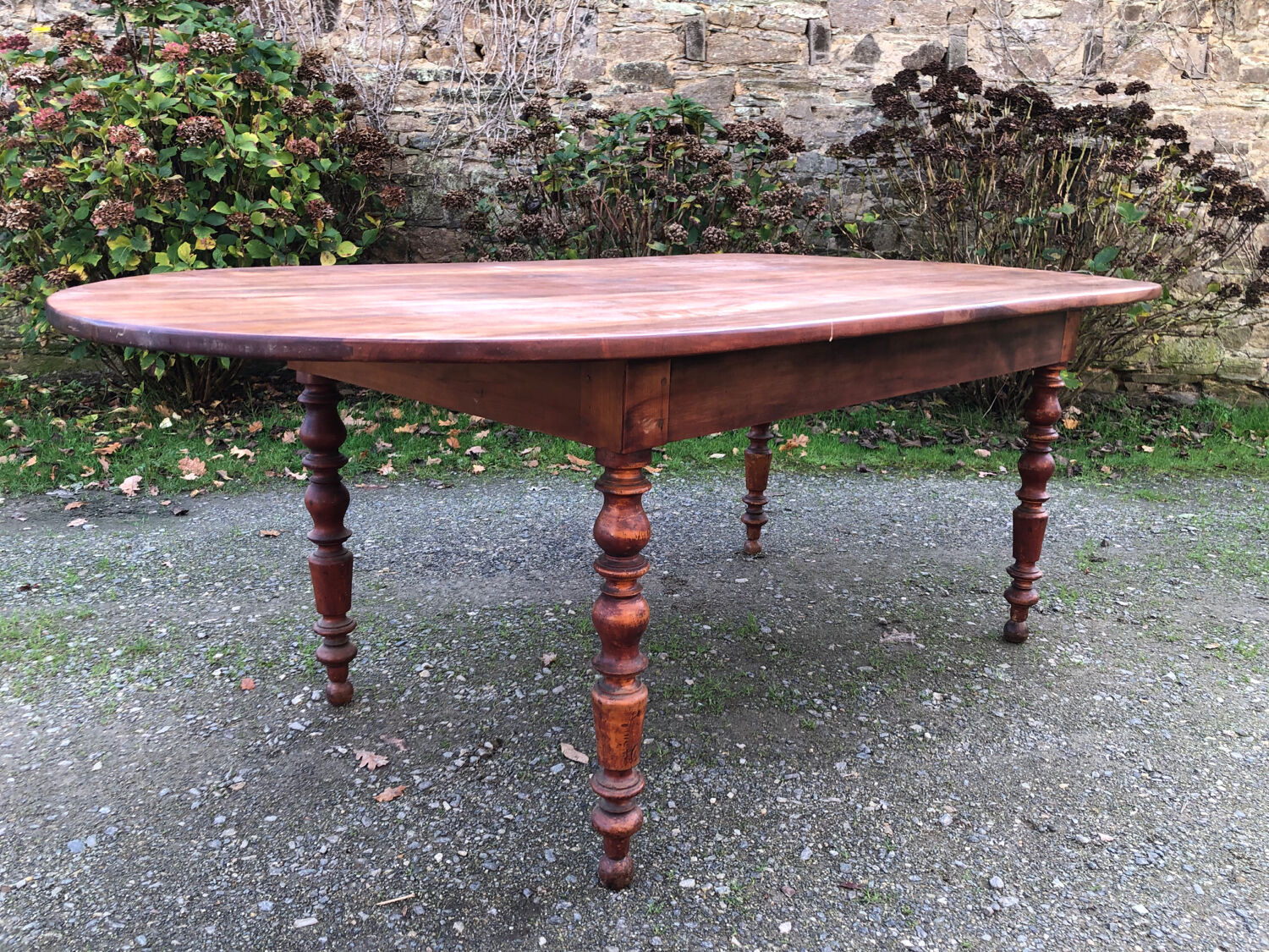 Antique cherry wood farmhouse table with rounded ends