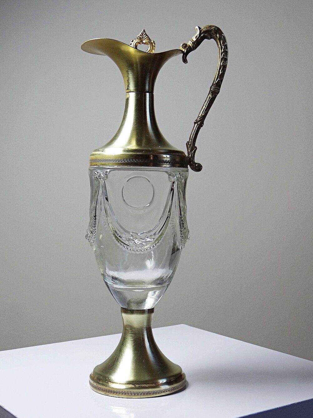 Vintage decorative jug in moulded glass and gilded brass, Italy circa 1980.