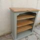 Green-grey library, wooden shelf and shelves in natural wood.