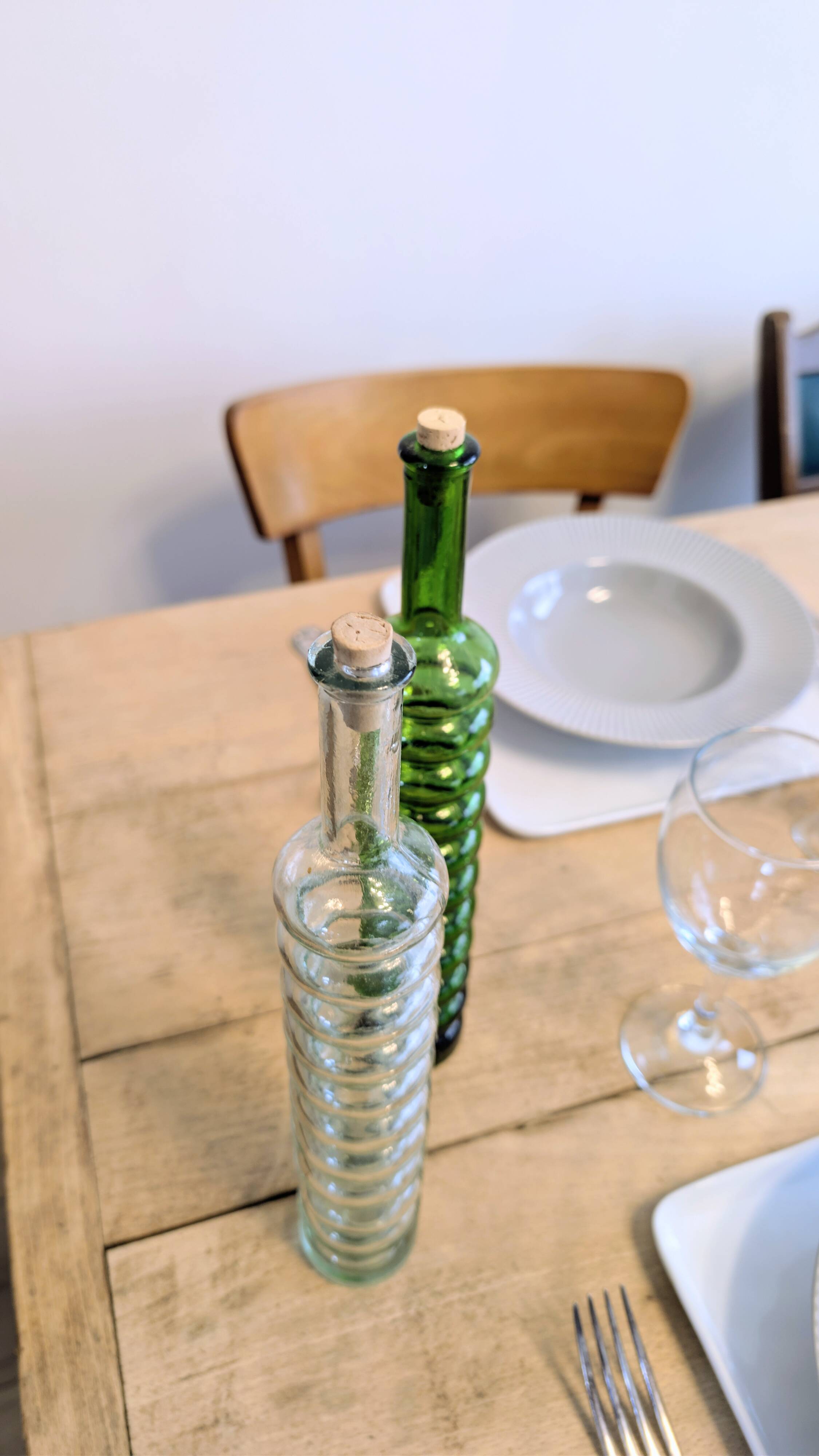 Pair of vintage ribbed blown glass bottles with cork stoppers.