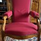 Antique Louis Philippe armchair in walnut and red fabric.