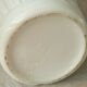 Thick white porcelain vase with relief decoration of a flying duck.