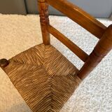 Old, rustic children's chair, small wooden and straw chair.