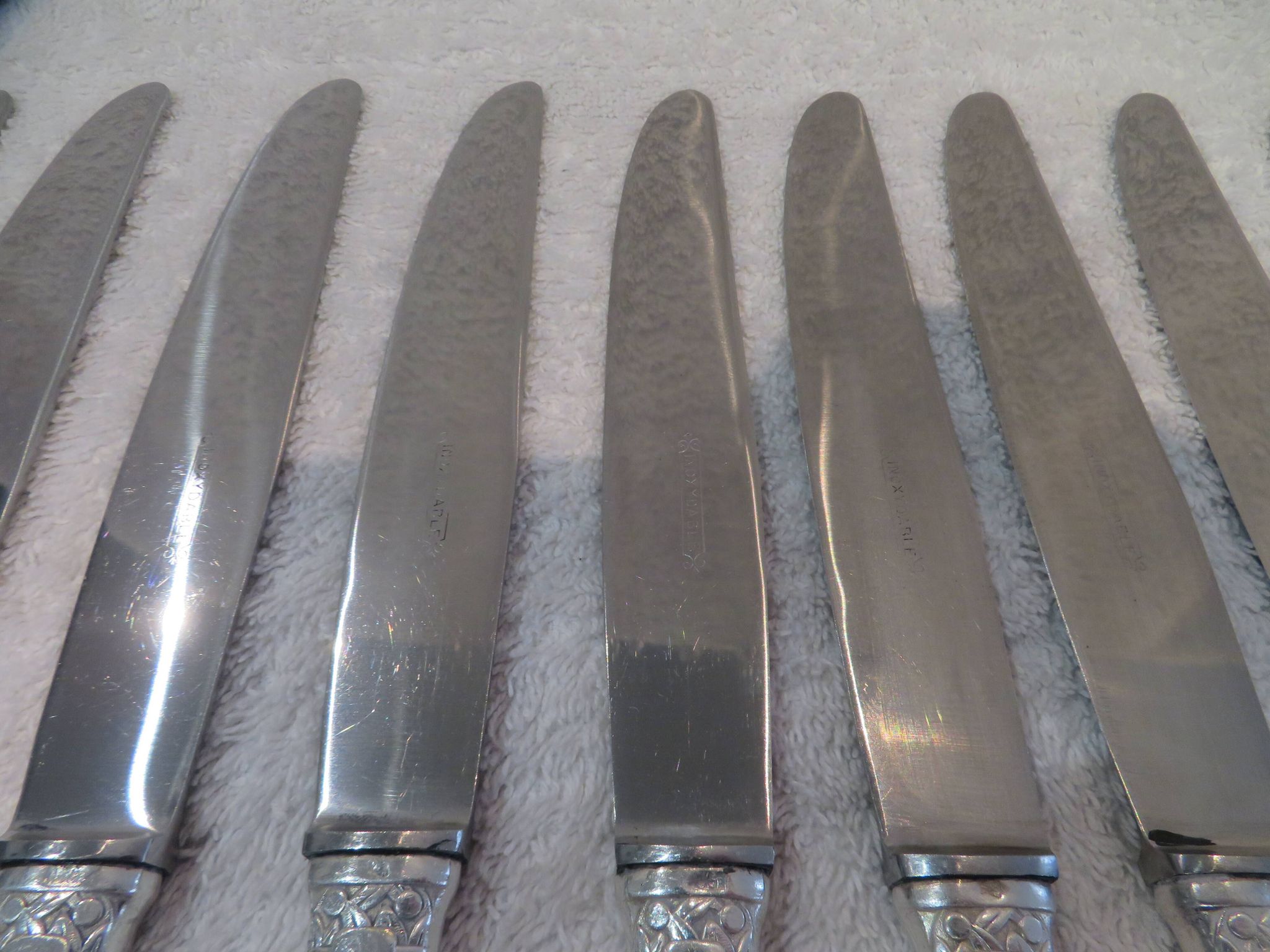 12 silver plated table knives by Argit goldsmith? Art Deco floral bands
