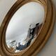 Miroir œil de sorcière vintage en bois doré