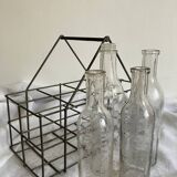 4 graduated bottles in their bottle holder