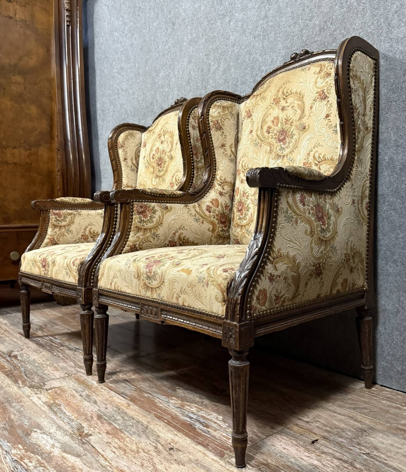 Large pair of Louis XVI style carved wooden wingback armchairs