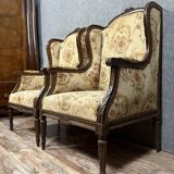 Large pair of Louis XVI style carved wooden wingback armchairs