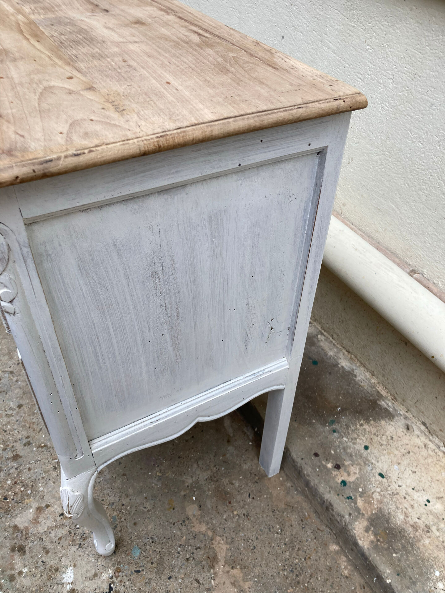 Adorable small chest of drawers or weathered white console.