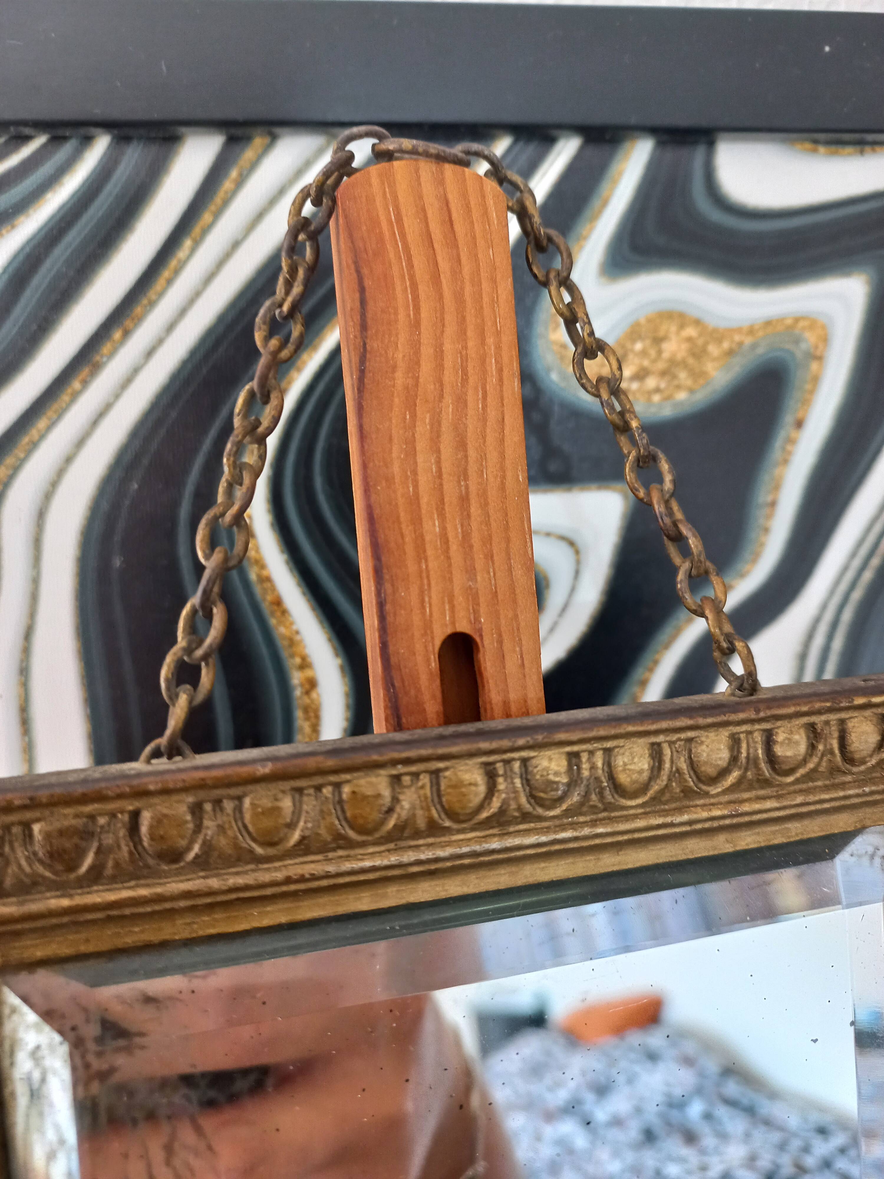 Small vintage mirror in gilded wood, bevelled glass with chain.