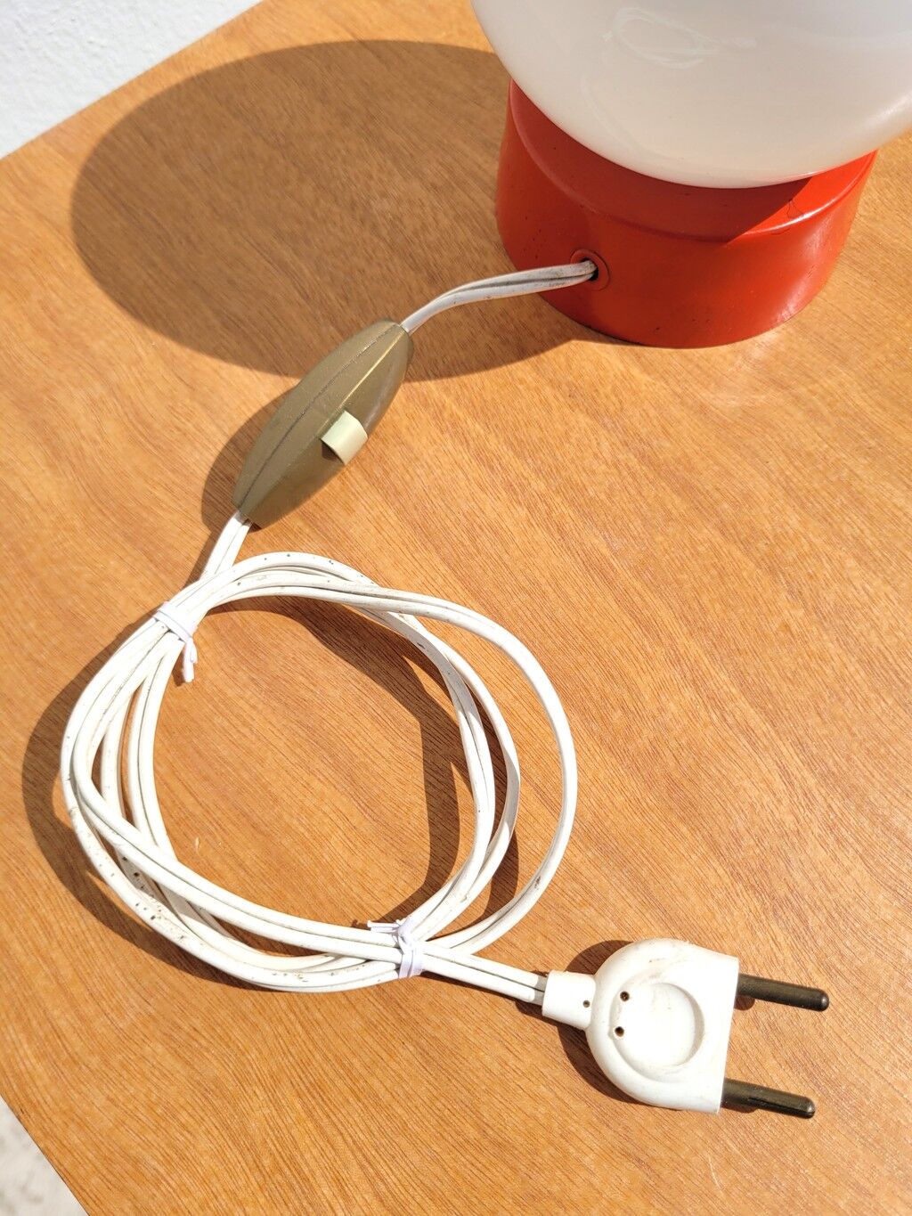 Small vintage opaline ball lamp with an orange base.