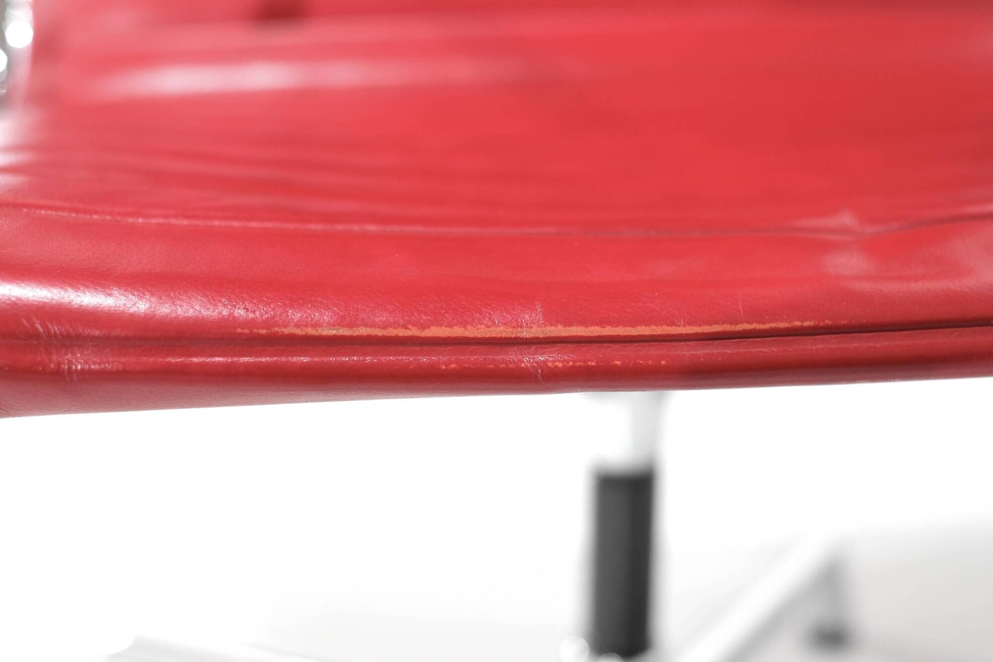 "EA 108" armchair in red leather, designed by Charles and Ray Eames for Vitra,
