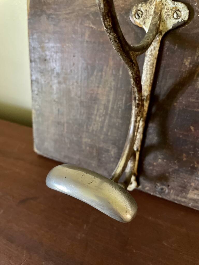 Patinated wood and metal coat rack from the 1950s.