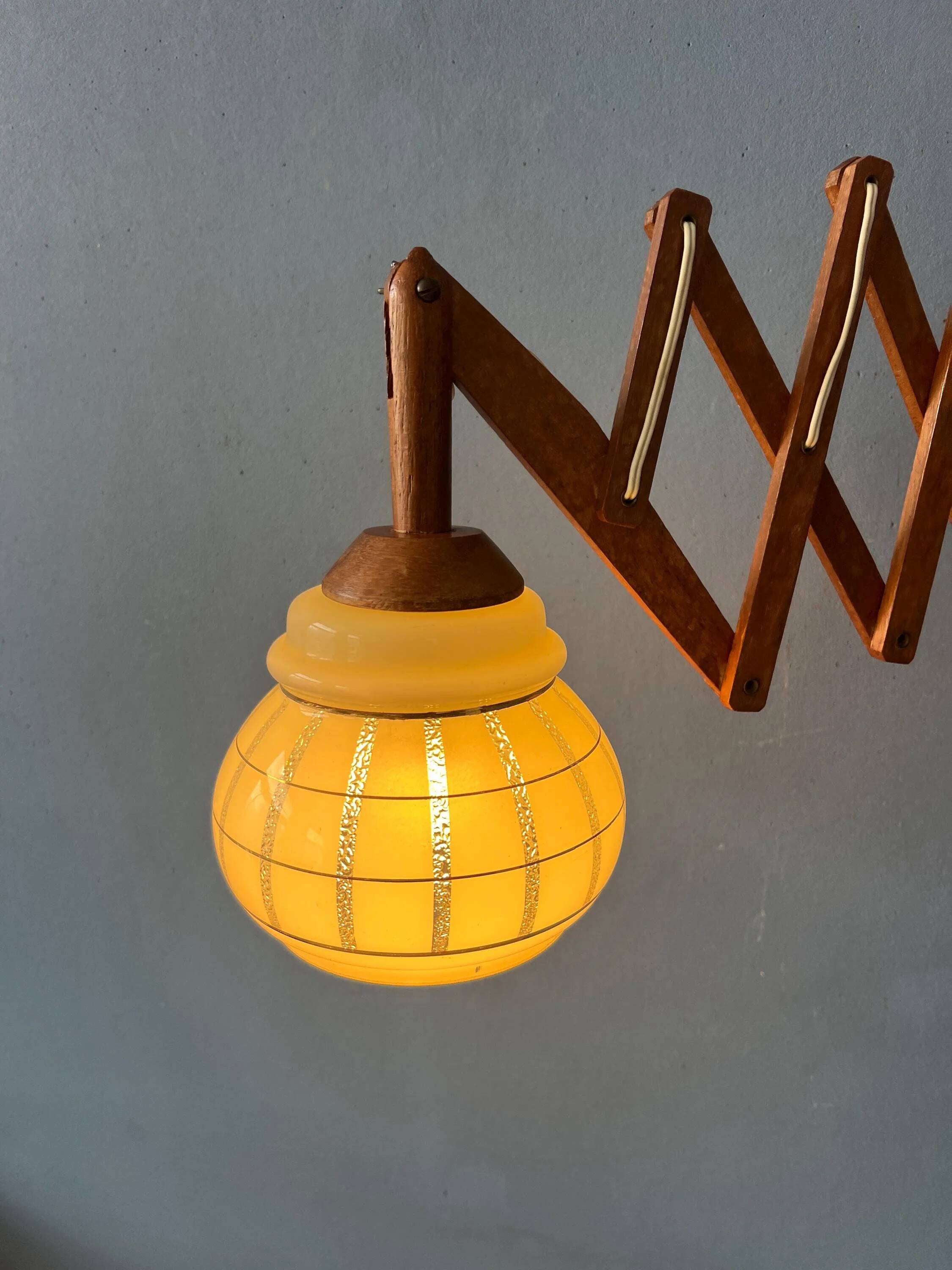 Vintage wall lamp with teak wood scissors and glass shade.