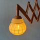 Vintage wall lamp with teak wood scissors and glass shade.
