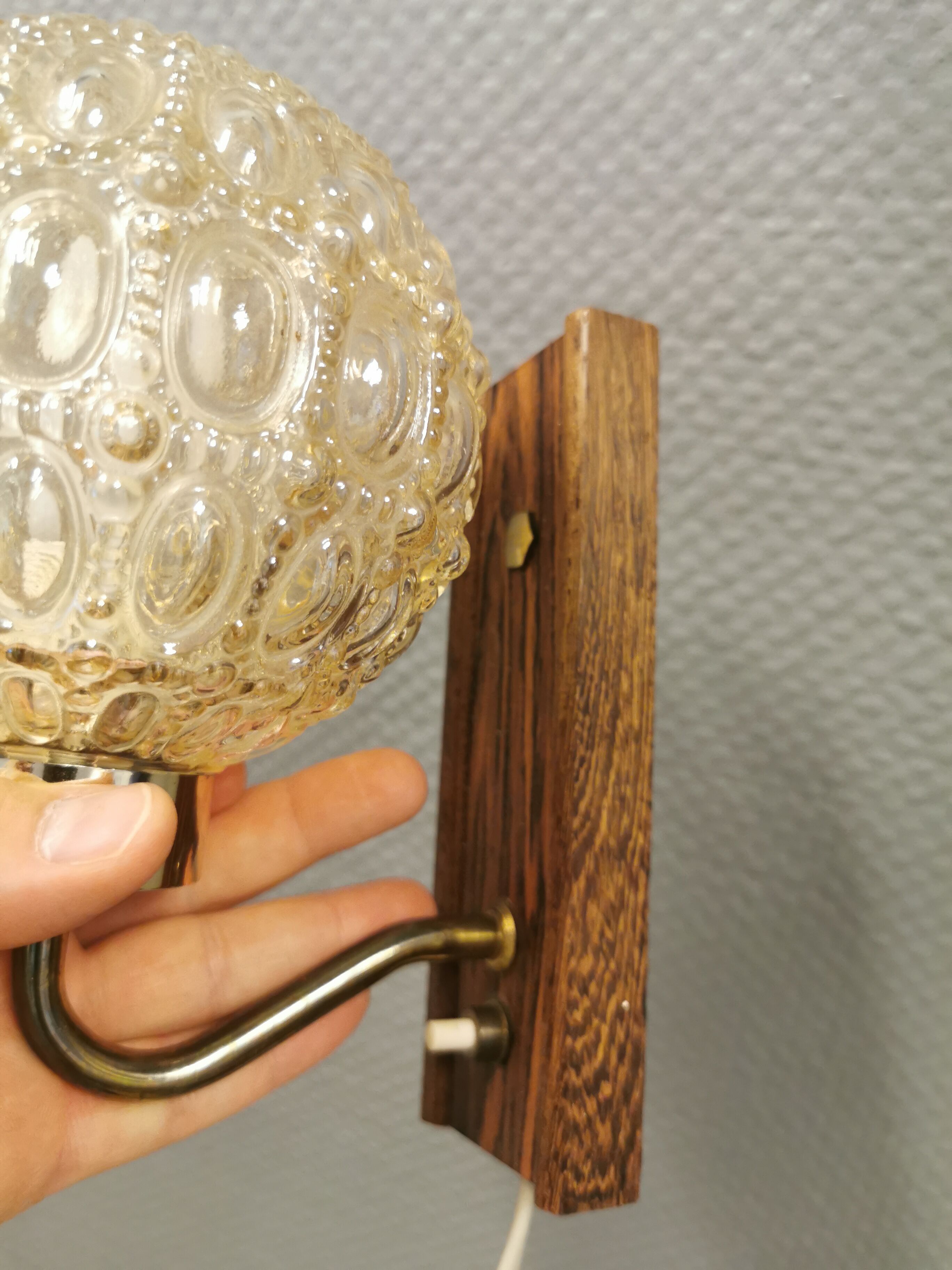 Wall light in rosewood with bobble glass ball shade.