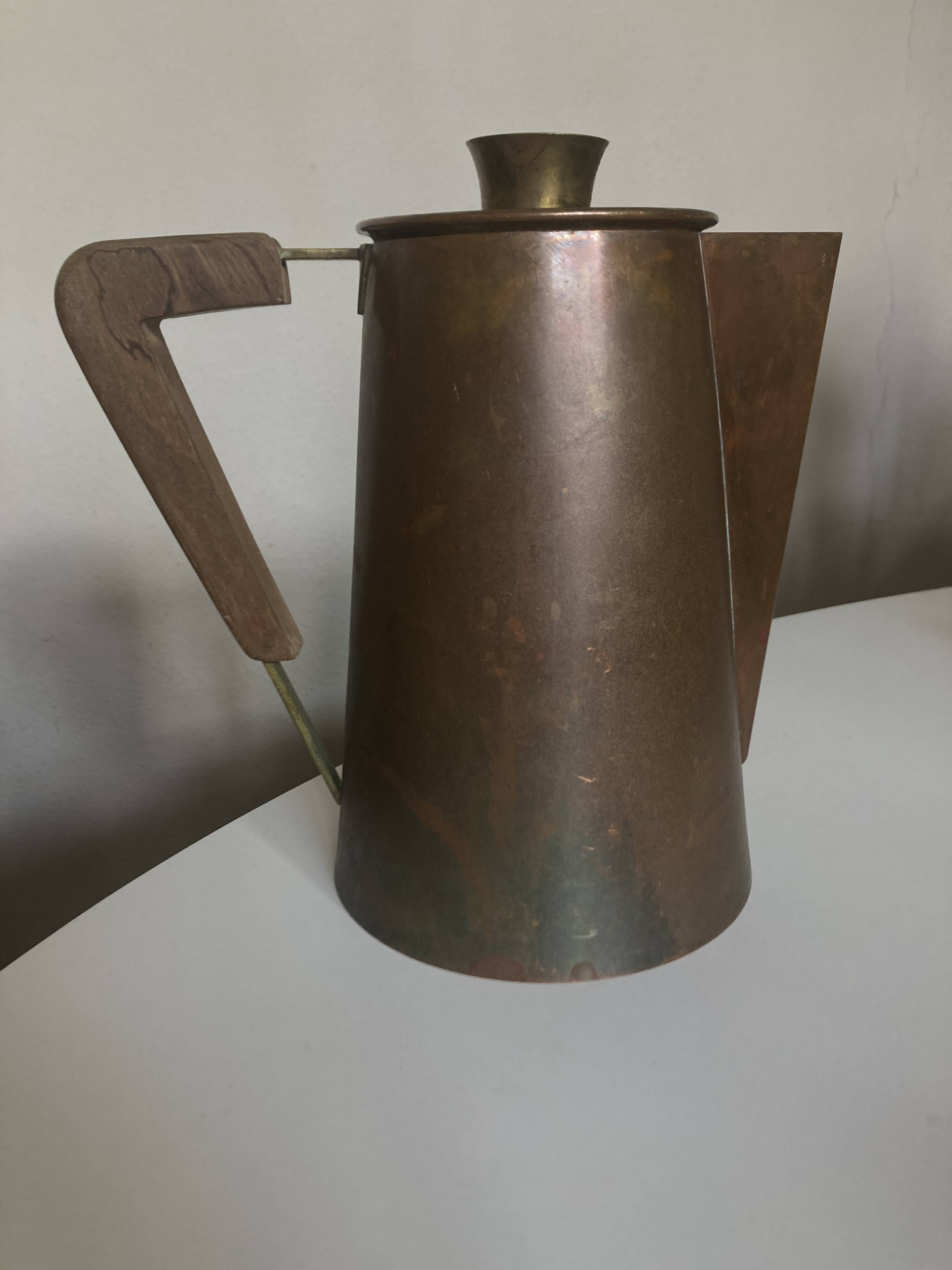 Modernist Italian pitcher design from the 1960s in patinated wood and metal.