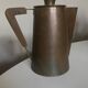 Modernist Italian pitcher design from the 1960s in patinated wood and metal.