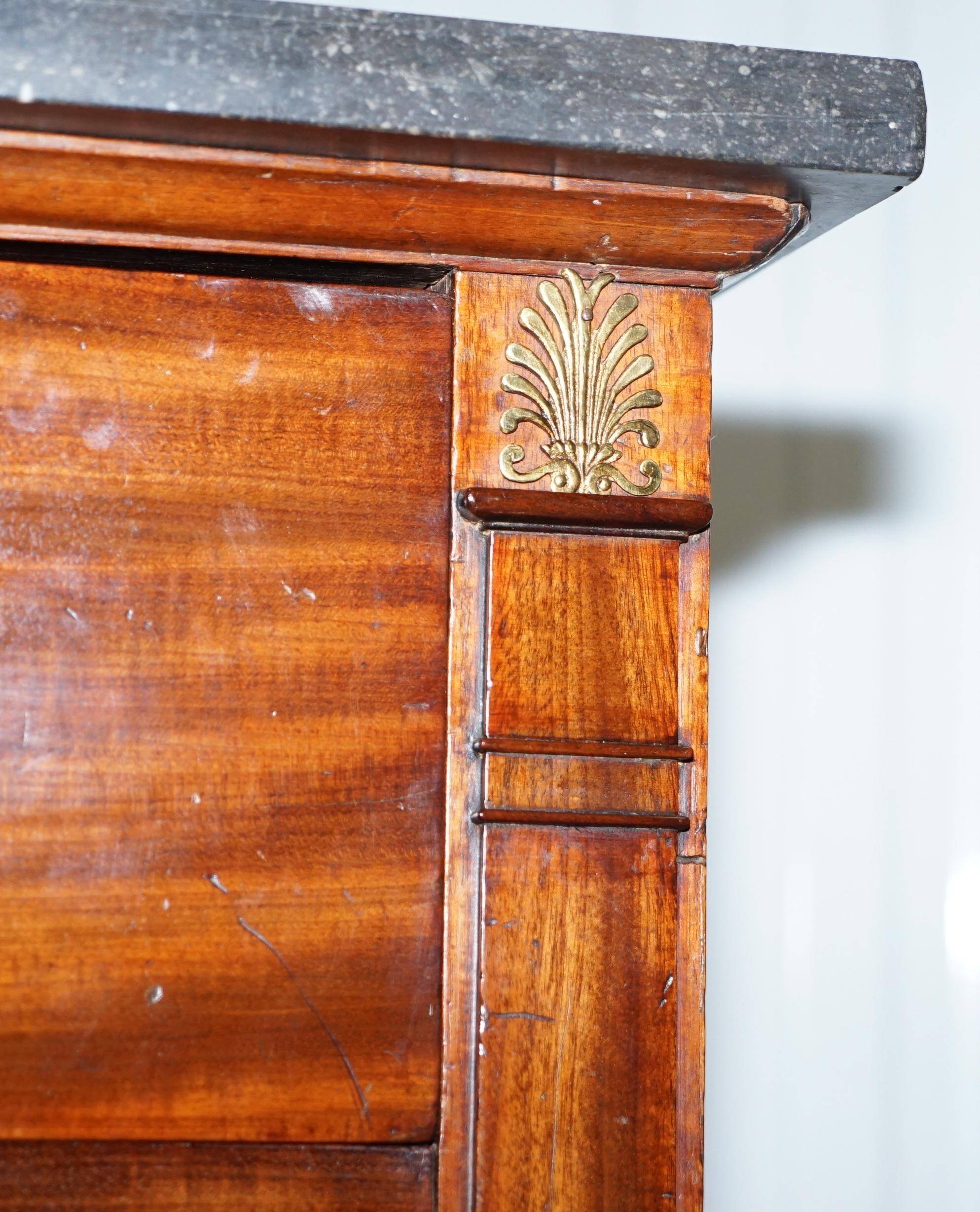 19th-century Empire commode with a marble top and lion paw feet.