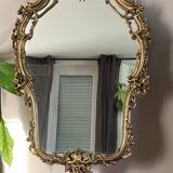 Rocaille style mirror from the 20th century in wood and gilded stucco, Putto on the pediment
