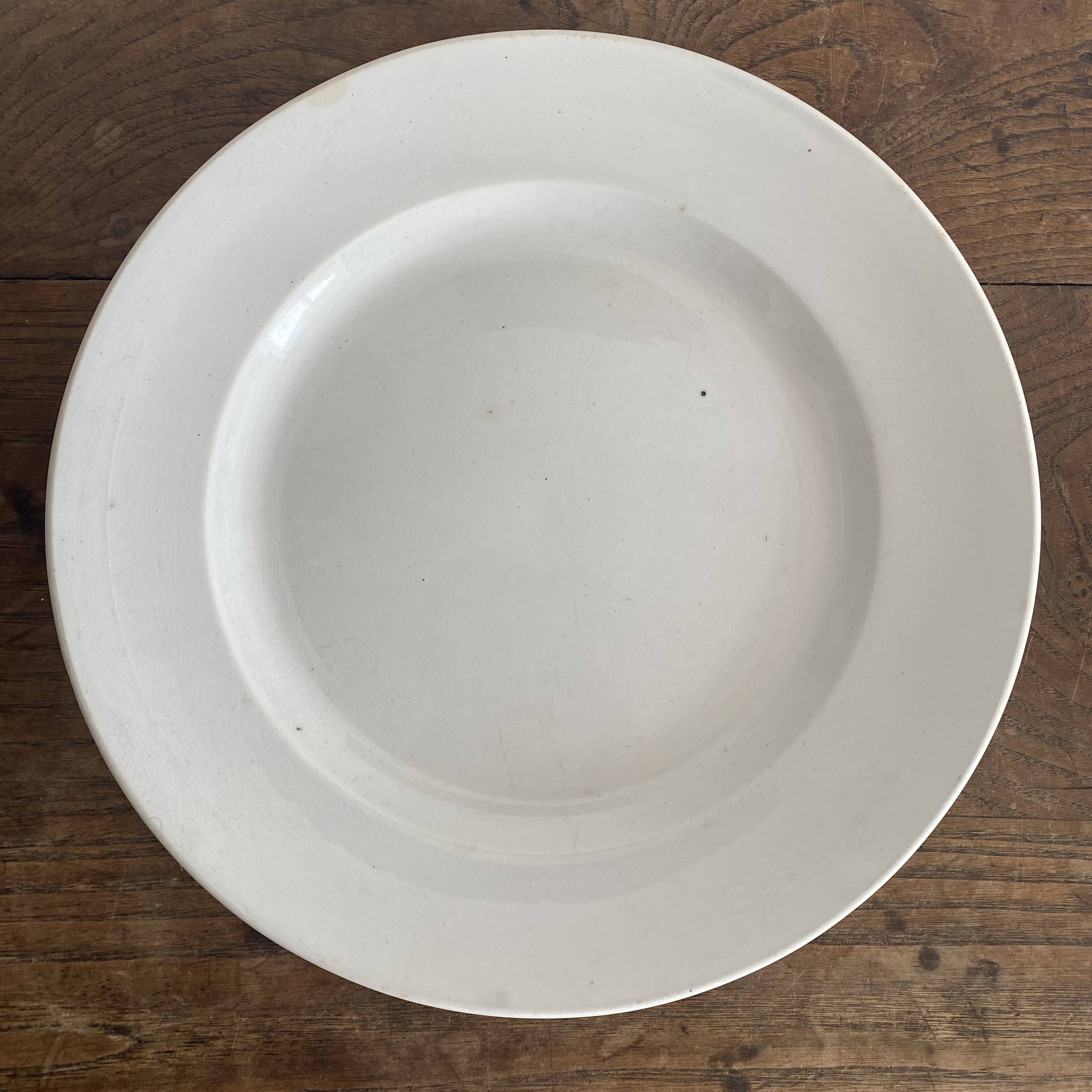 Set of large round white earthenware dishes from Creil and Montereau, 19th century