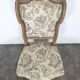 Louis XV style armchair in natural wood with floral fabric.