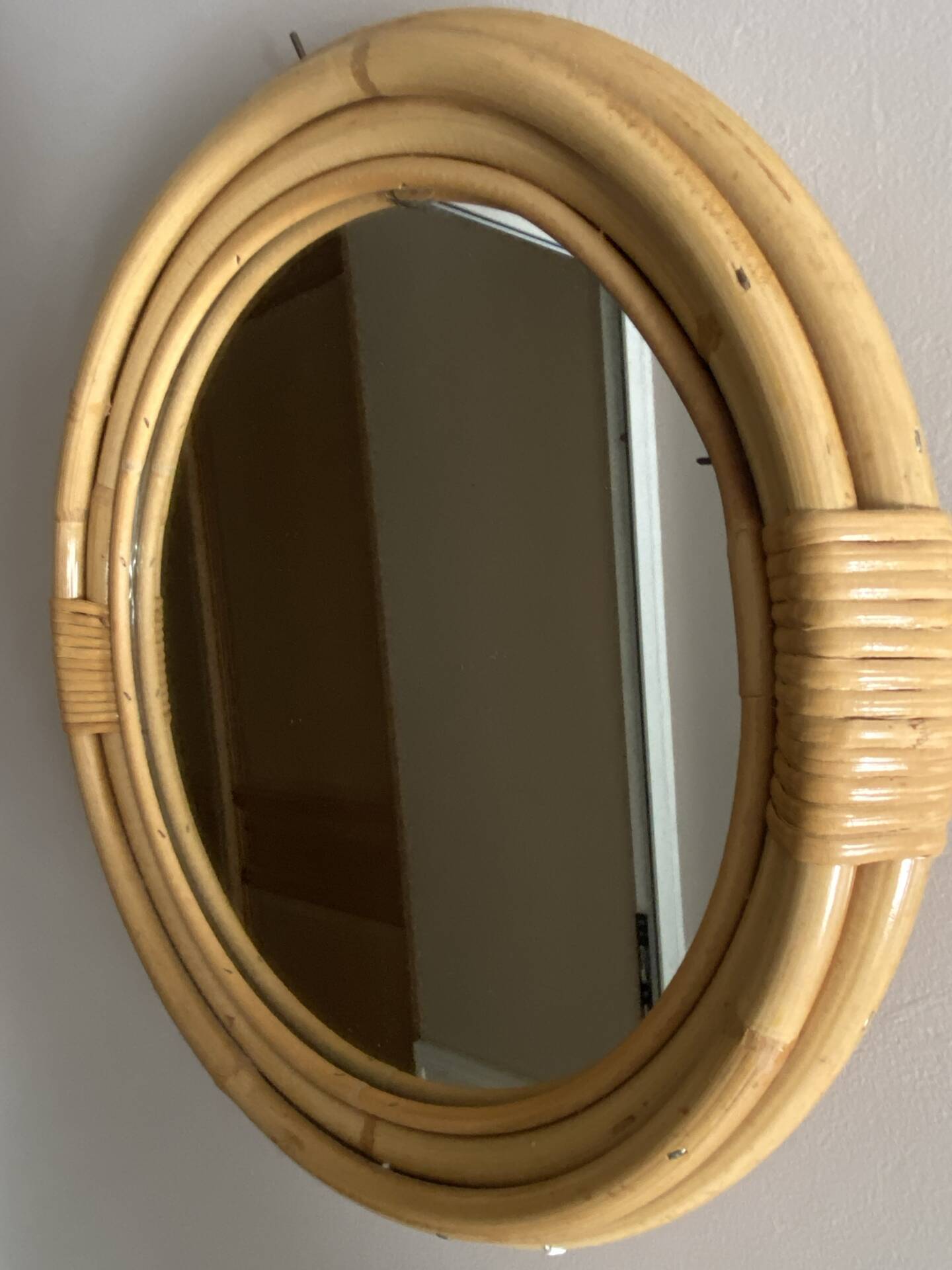 Round mirror from the 1960s with a frame made of rattan and metal.