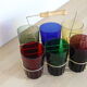 Set of 6 coloured glasses in their brass holder, basket