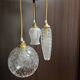 Suspension with three cut glass globes and a diamond tip.