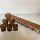 Six wooden egg cups and their rope holder