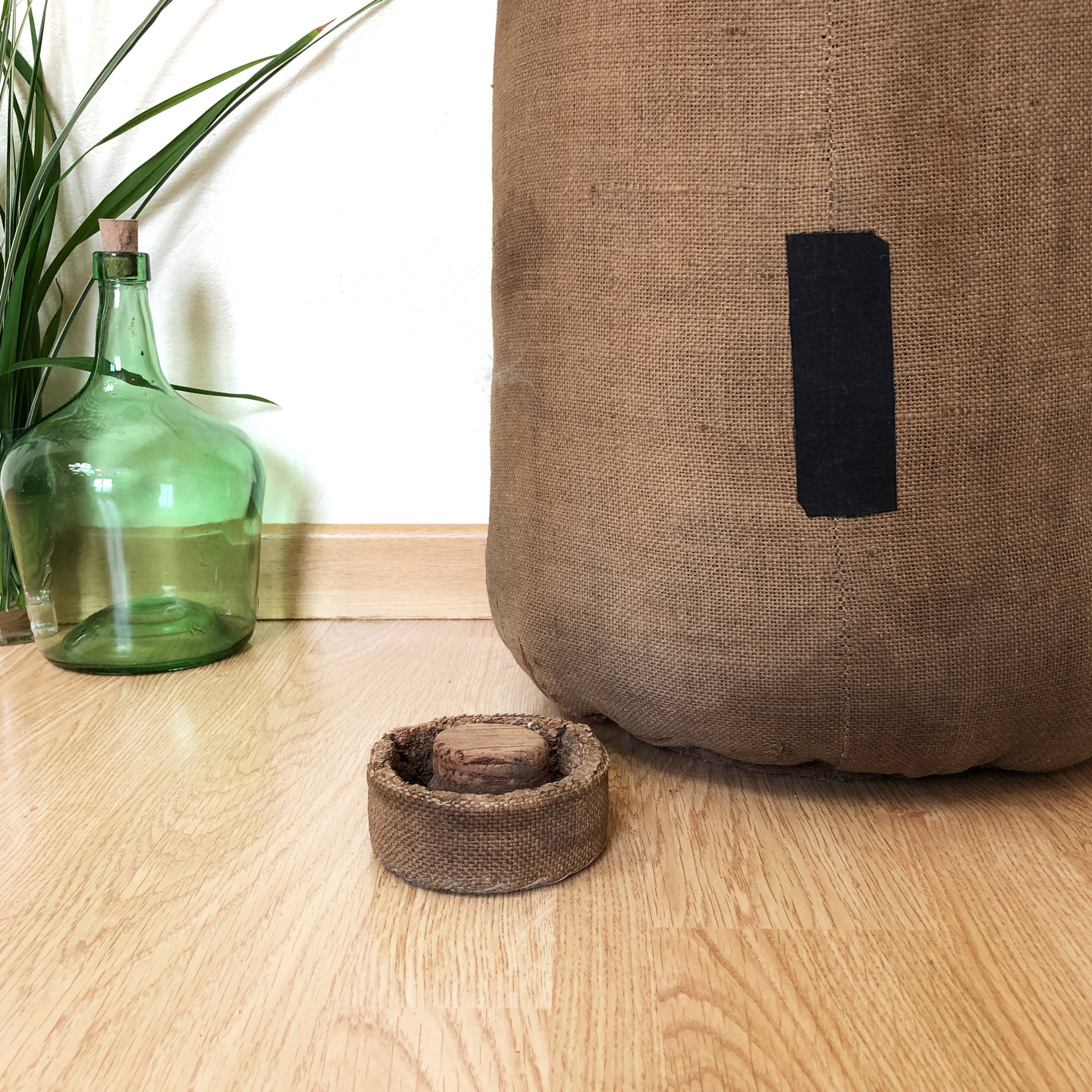 Big demijohn with burlap