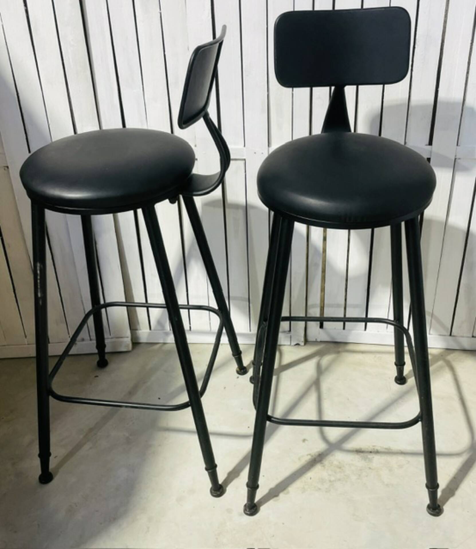 Pair of black bar stools in industrial and contemporary style.