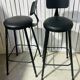 Pair of black bar stools in industrial and contemporary style.