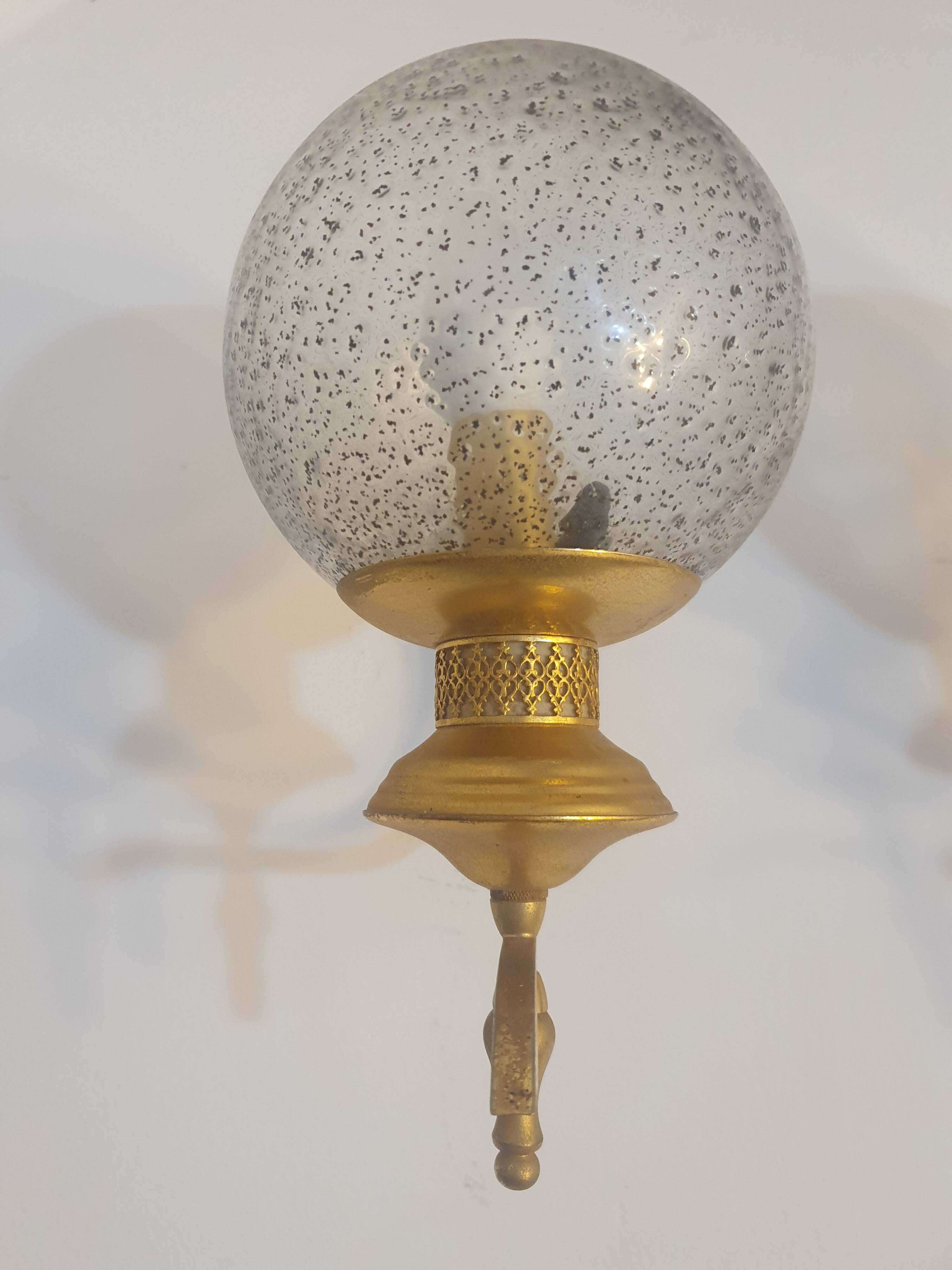 Pair of vintage gold wall sconces with transparent globes