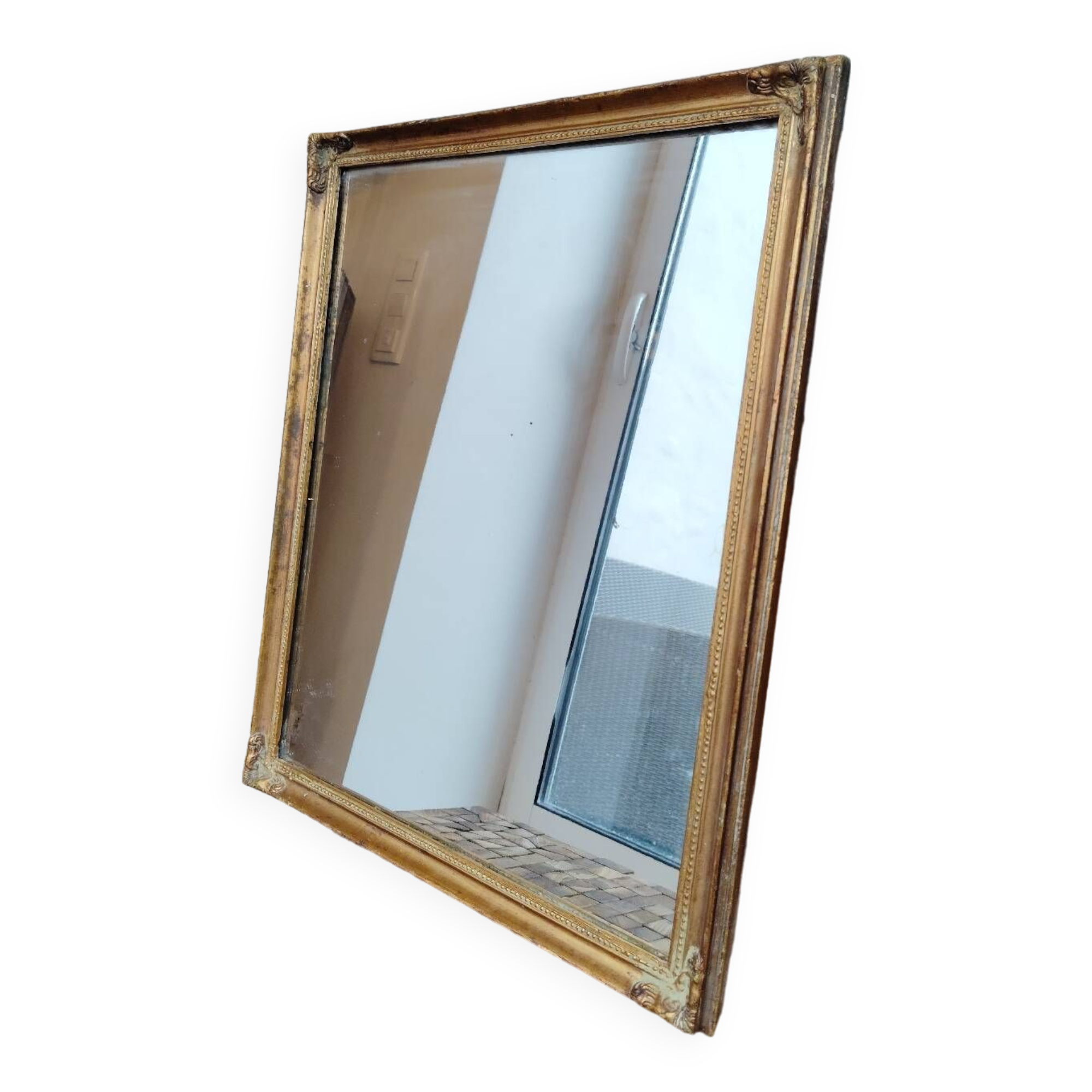 Miroir en bois, doré à la feuille d'or.