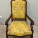 Louis XV style cabriolet armchair in solid wood, yellow floral fabric.