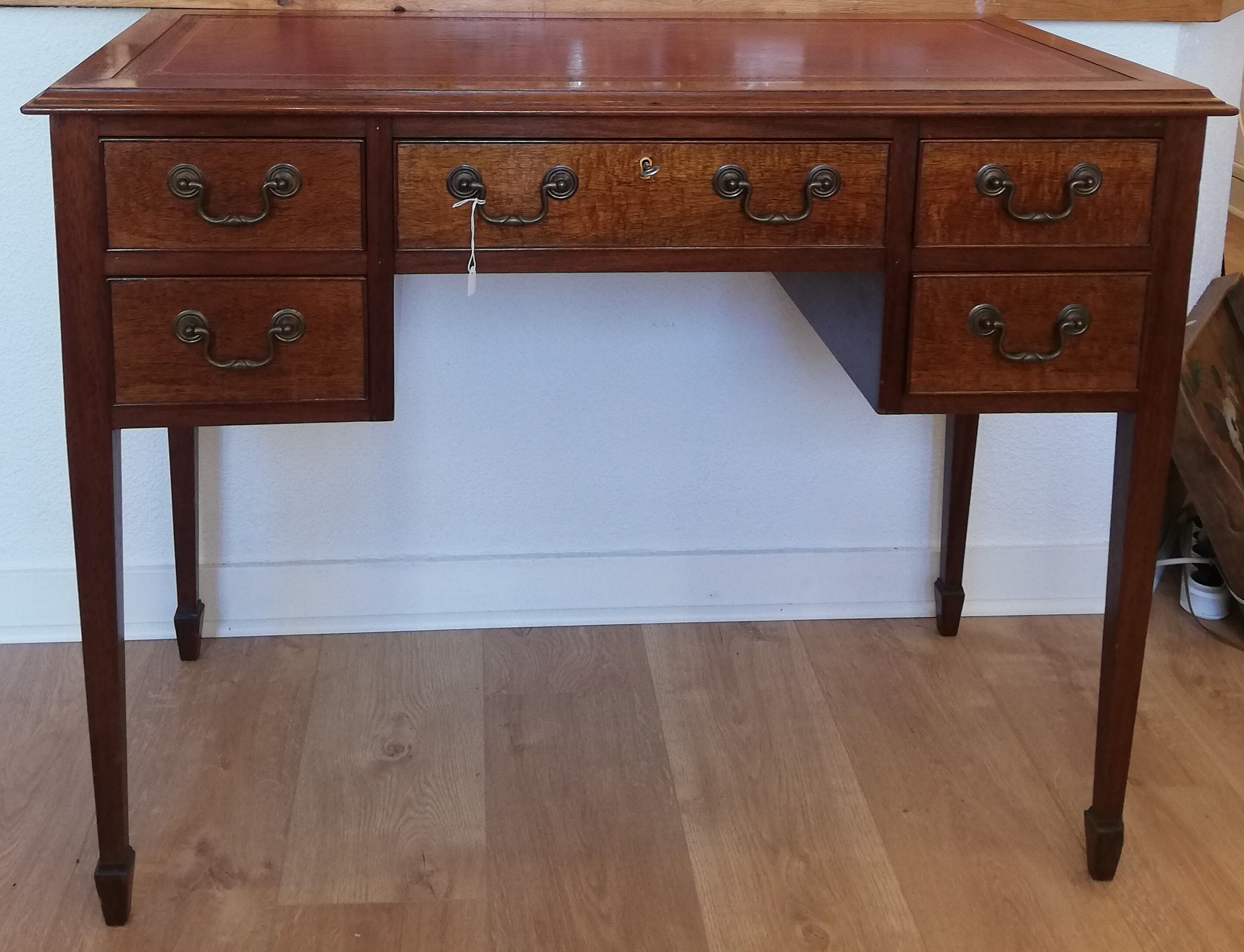 English wooden desk on top of leather