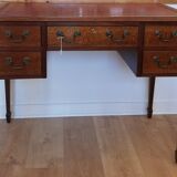 English wooden desk on top of leather