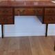 English wooden desk on top of leather