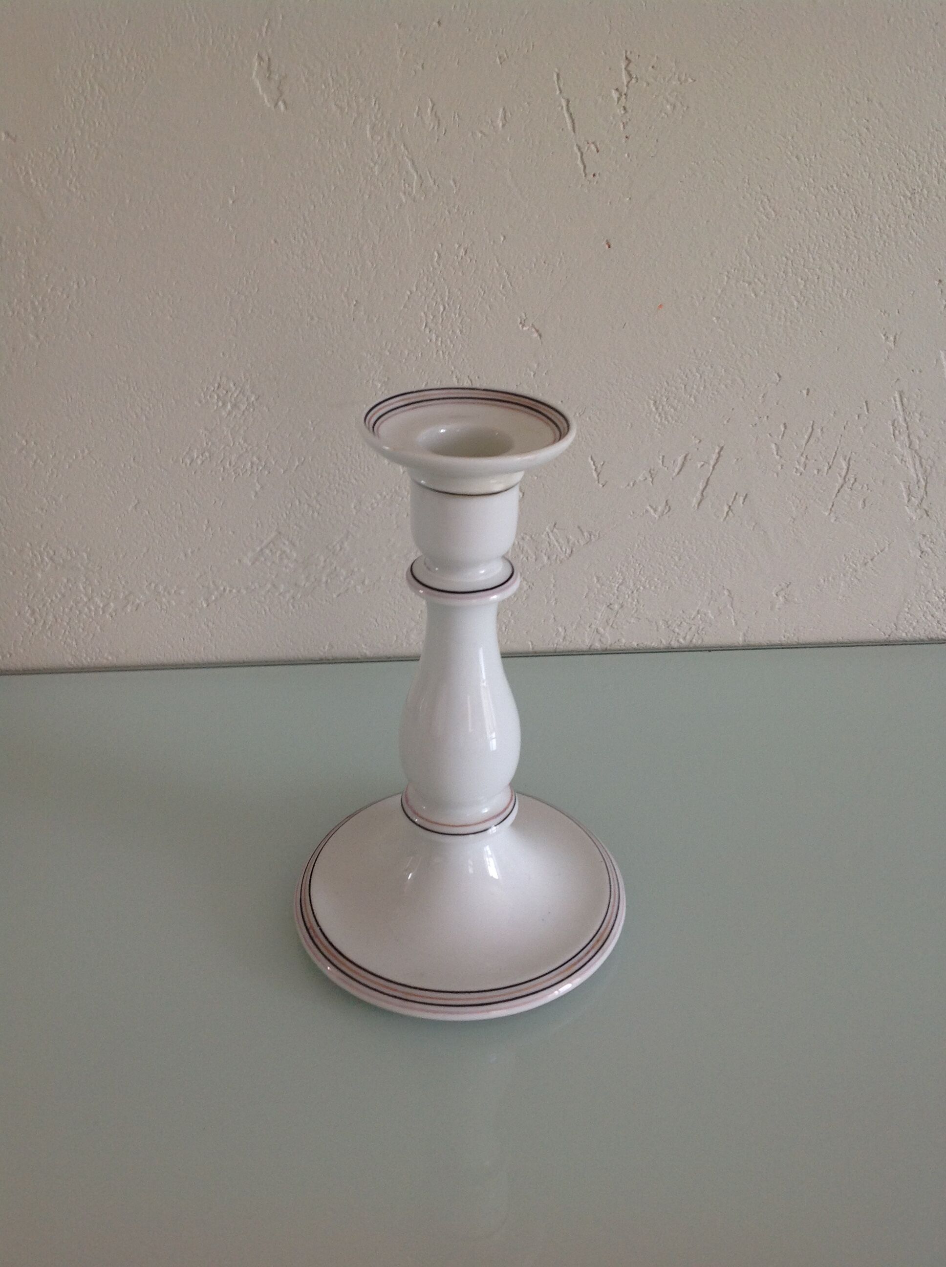 Old white earthenware candlestick