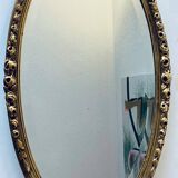 Miroir mural ovale doré
