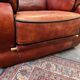 living room in patinated leather and brass from the 80s