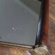 Rectangular mirror tray with wooden handles and gilding.