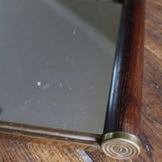 Rectangular mirror tray with wooden handles and gilding.