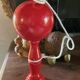 Large red wooden cup-and-ball game, 9 cm in diameter.