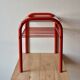 Vintage side table in red tubular steel - smoked glass window - 1980s