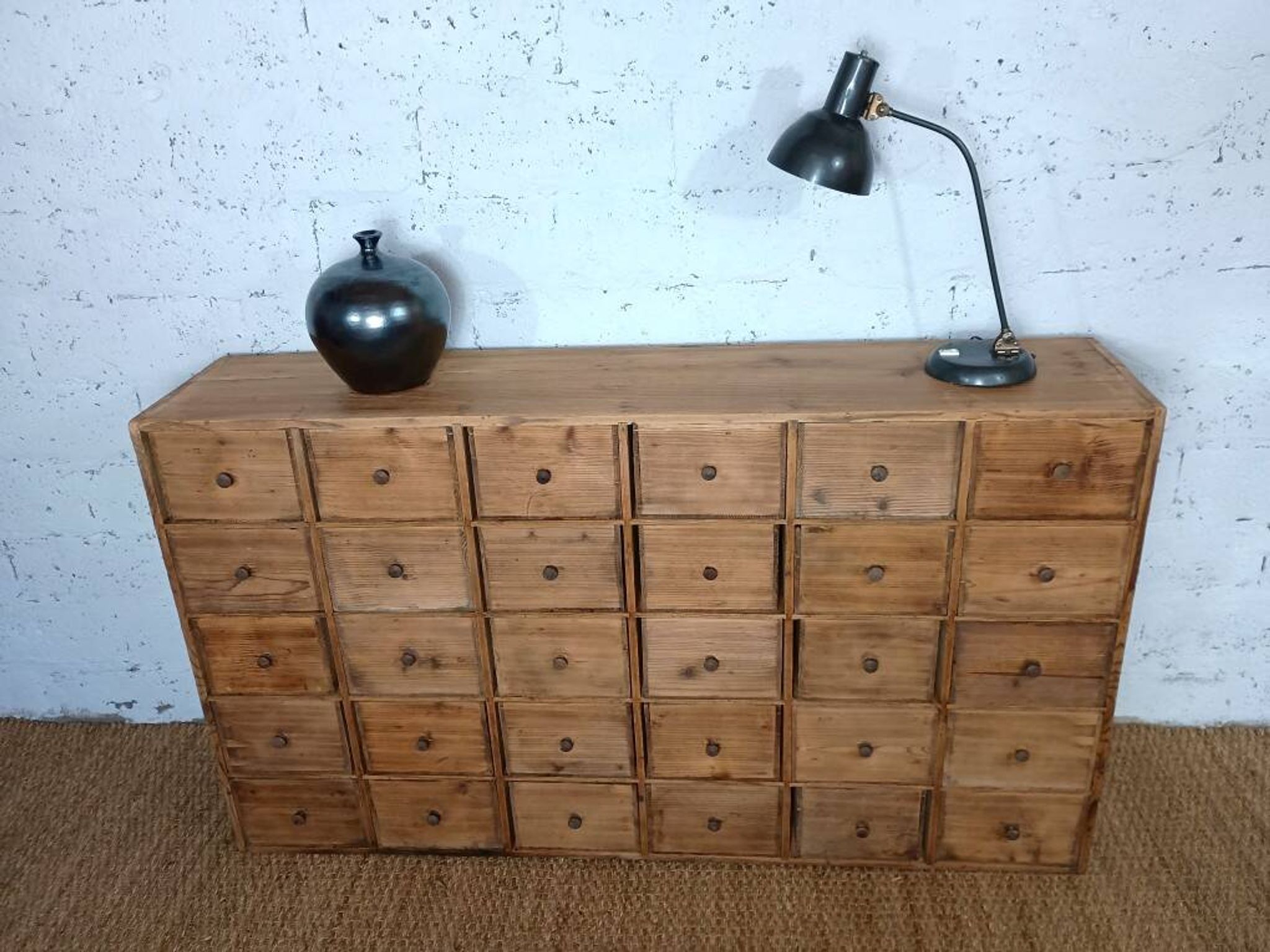 Industrial or apothecary workbench with 30 vintage wooden drawers.