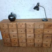 Industrial or apothecary workbench with 30 vintage wooden drawers.