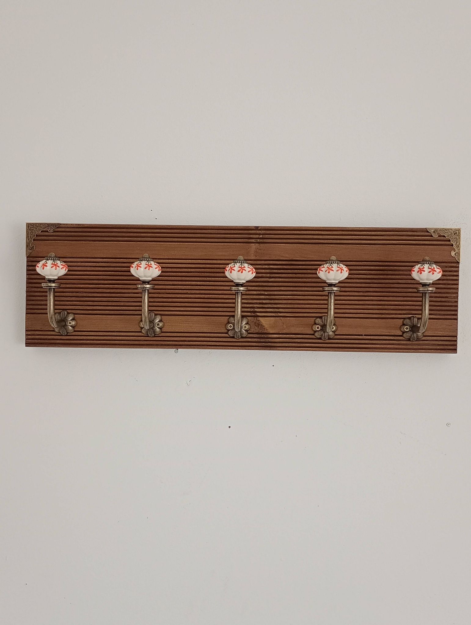 Vintage wall coat rack with 5 ceramic hooks featuring floral patterns - wood
