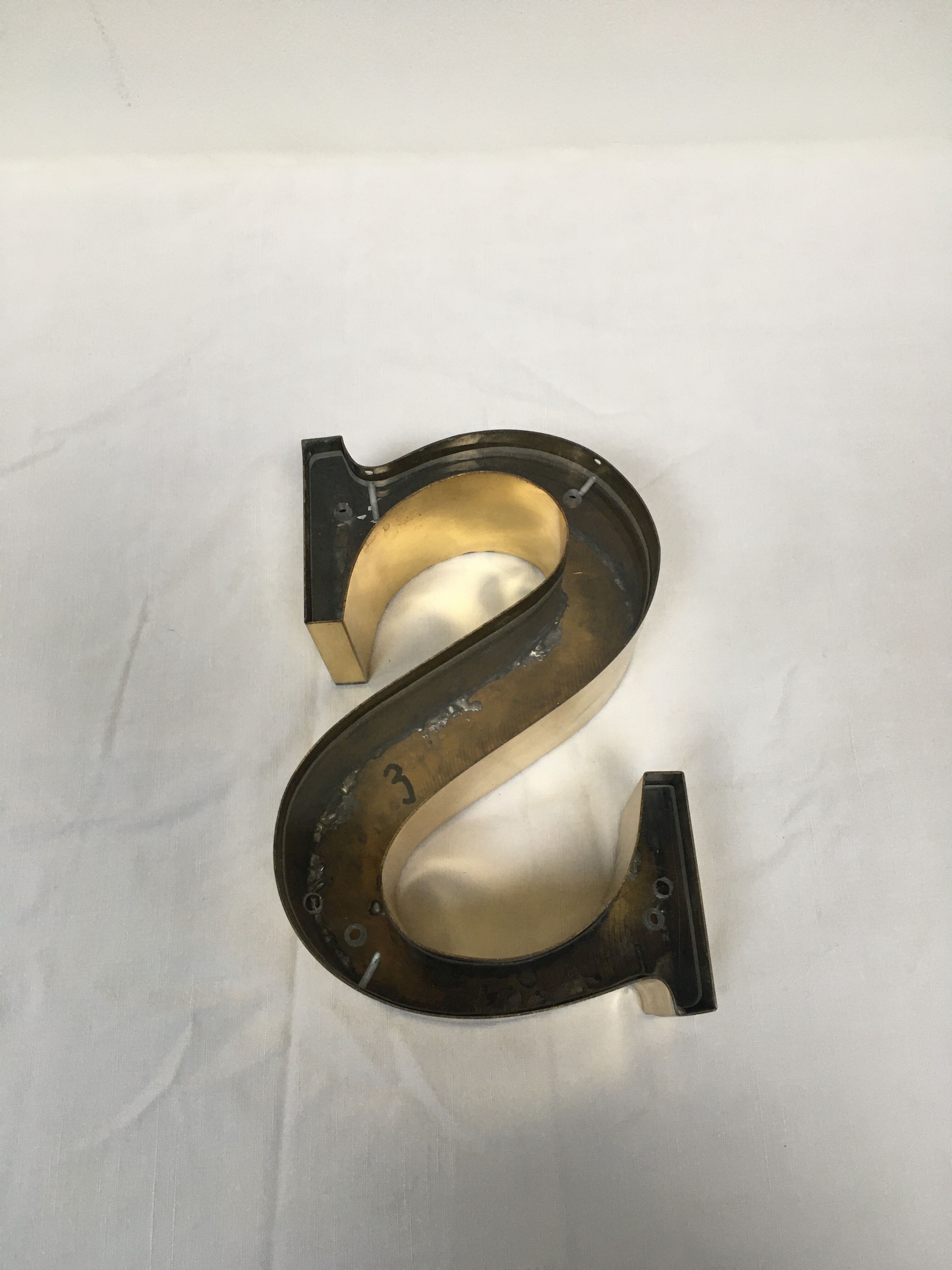 Brass sign letter S